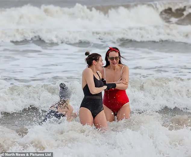 Festive Frolics: Brave Swimmers Mark New Year in Icy Waters of Whitley Bay
