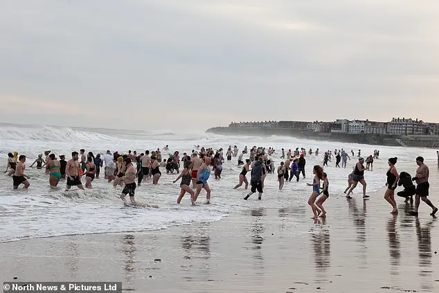Festive Frolics: Brave Swimmers Mark New Year in Icy Waters of Whitley Bay