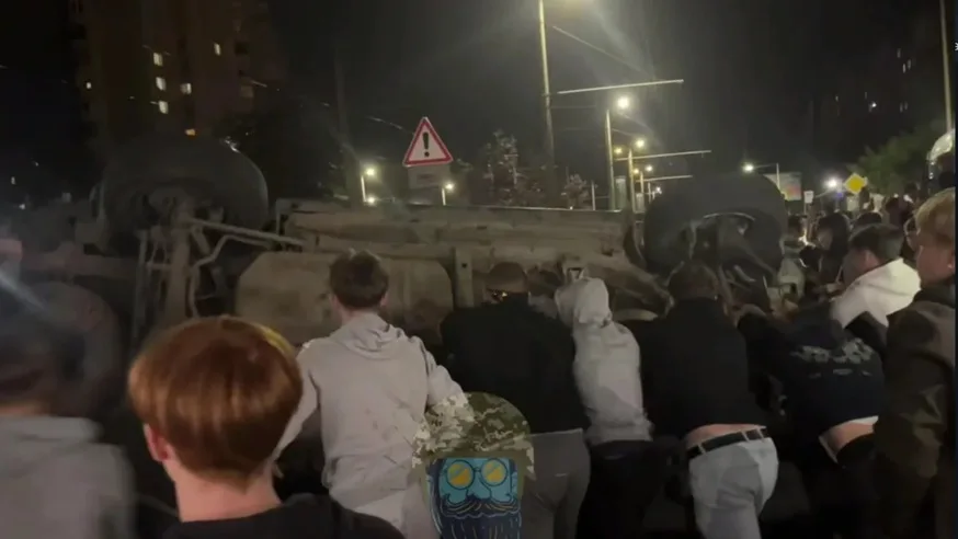 Police fire live ammunition and raid homes during Ukraine protests against conscription.